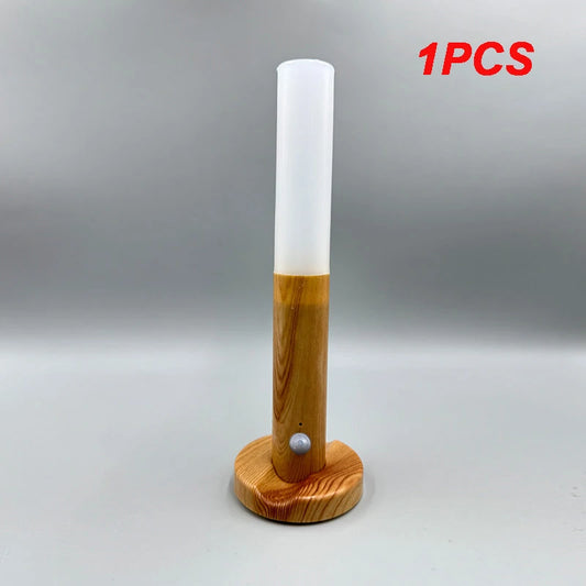 Wooden lamp with white cylindrical shade on a gray background