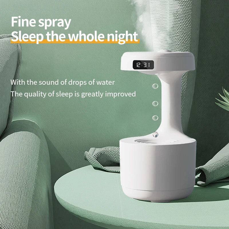 White humidifier on a green table with text about its benefits, shown against a green wall.