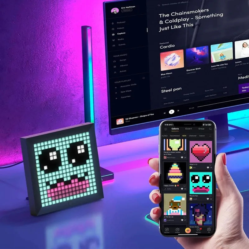 Digital display with pixel art design next to a smartphone showing a music app interface.