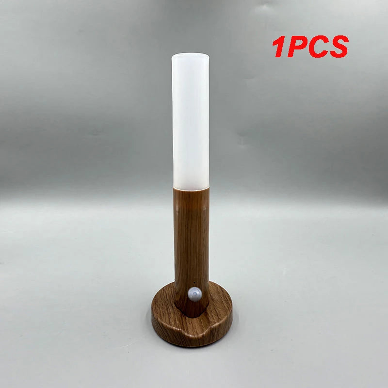 Tall cylindrical light fixture with wooden base on a gray background